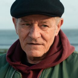 A thoughtful older man by the sea: residential dementia care in Norwich starts with the person, not the diagnosis